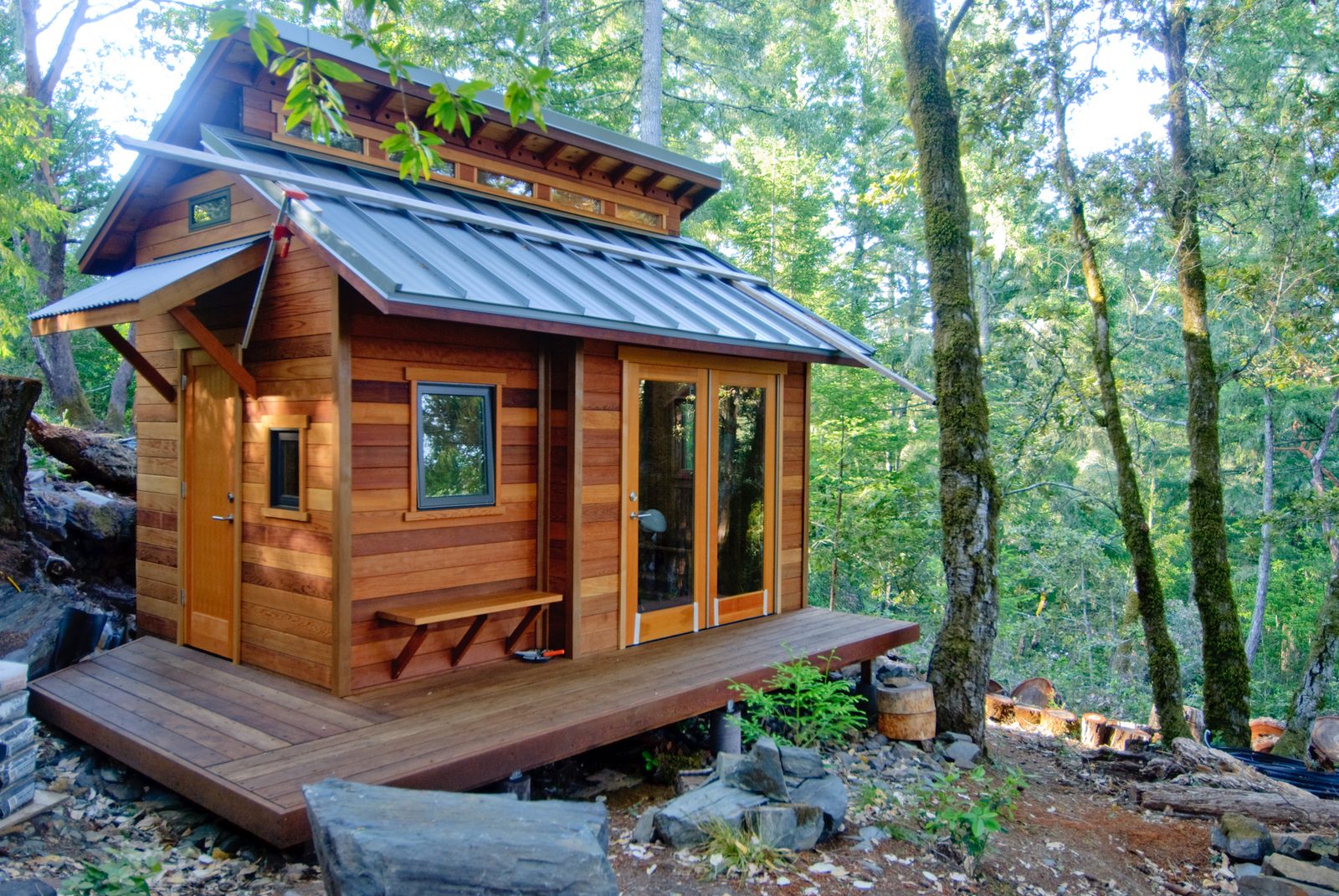 Small wooden ADU cabin with deck in a wooded Waldorf backyard